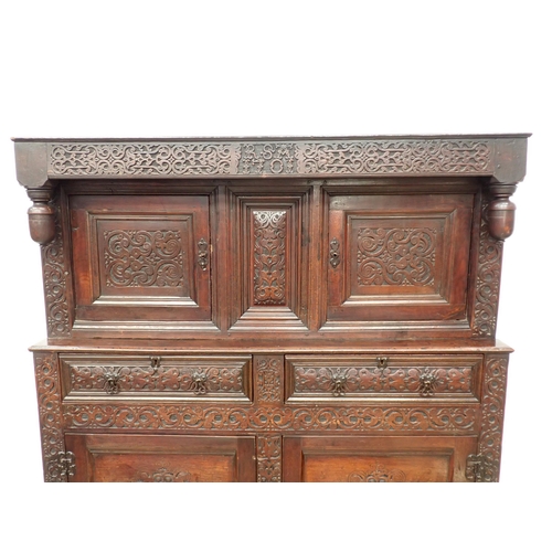 428 - An early 18th Century oak Court Cupboard initialled and dated 'RSA 1701' with leafage carved decorat... 