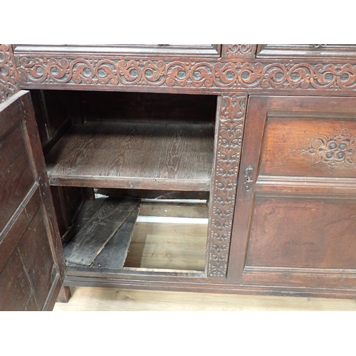 428 - An early 18th Century oak Court Cupboard initialled and dated 'RSA 1701' with leafage carved decorat... 