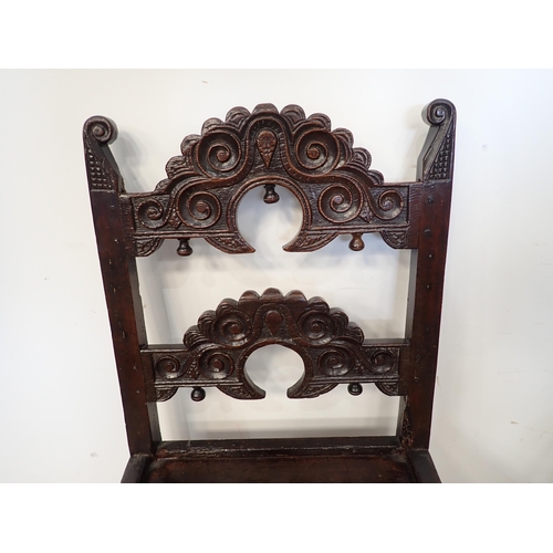 451 - Two 17th Century and later oak Derbyshire Chairs, one with inward scroll upright terminals and mount... 