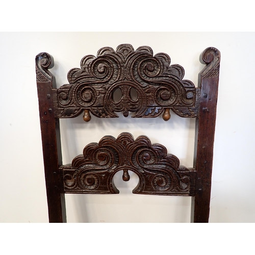 451 - Two 17th Century and later oak Derbyshire Chairs, one with inward scroll upright terminals and mount... 