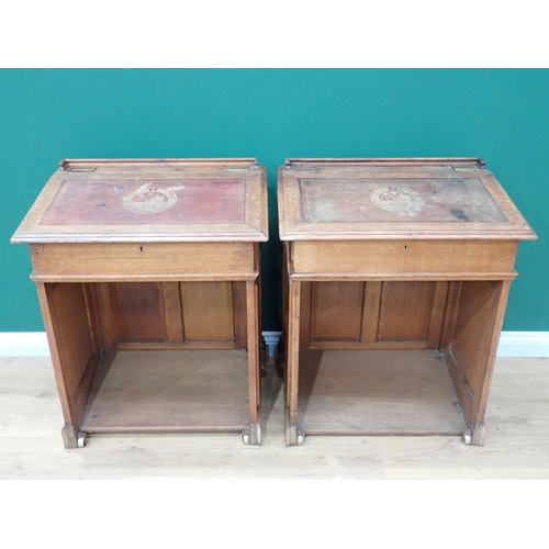 375 - A pair of Victorian panelled oak Desks, the hinged sloping top with inset writing surfaces decorated... 