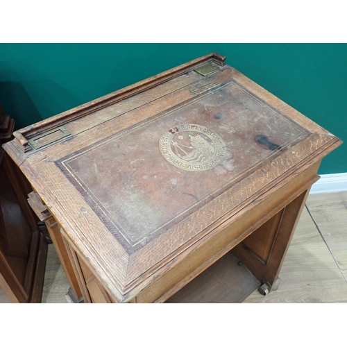 375 - A pair of Victorian panelled oak Desks, the hinged sloping top with inset writing surfaces decorated... 