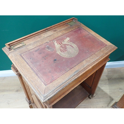 375 - A pair of Victorian panelled oak Desks, the hinged sloping top with inset writing surfaces decorated... 