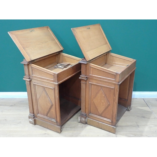 375 - A pair of Victorian panelled oak Desks, the hinged sloping top with inset writing surfaces decorated... 