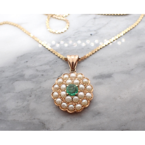 100 - An Emerald and Cultured Pearl Pendant claw-set round emerald within double frame of half pearls in 1... 