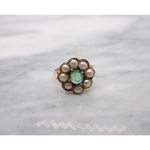 101 - An Emerald and Cultured Pearl Cluster Ring claw-set round emerald within a frame of pearls in rose g... 