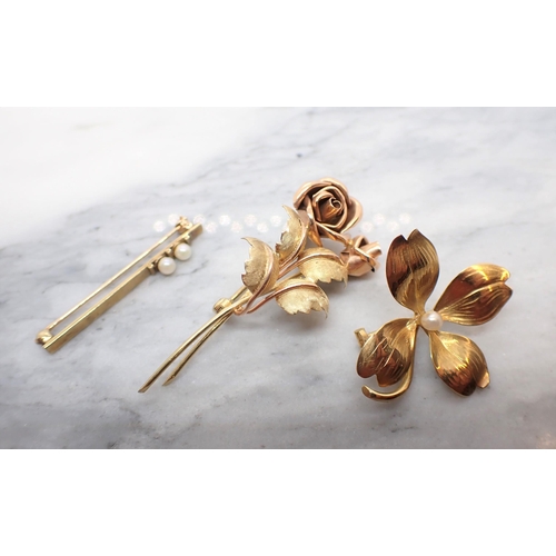 115 - A gold Rose Spray Brooch. Continental marks, a four leafed Clover Brooch set seed pearl and a 9ct go... 