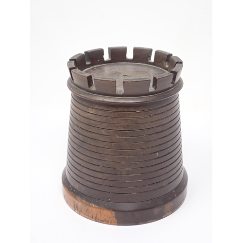 123 - A lignum vitae String Box in the form of a tapering cylindrical castellated tower, 5¼in H