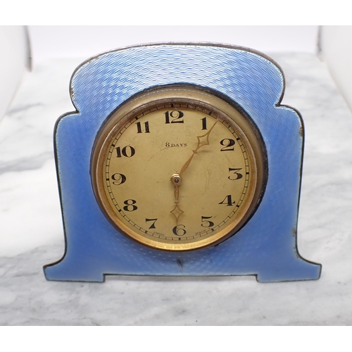 128 - An 8 day Alarm Clock in blue enamel surround, the cream dial with arabic numerals, movement marked B... 