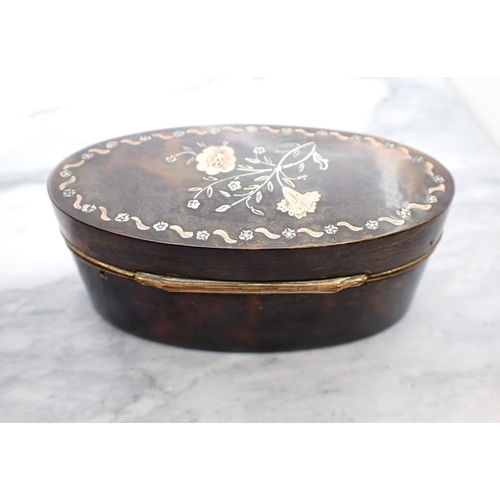 131 - A19th Century oval tortoiseshell Snuff Box the lid inlaid flowers with yellow metal mounts, 3 1/2in