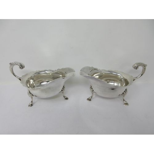 176 - A pair of Victorian silver Sauce Boats with shaped rims, leafage scroll handles on hoof feet, London... 