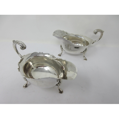 176 - A pair of Victorian silver Sauce Boats with shaped rims, leafage scroll handles on hoof feet, London... 