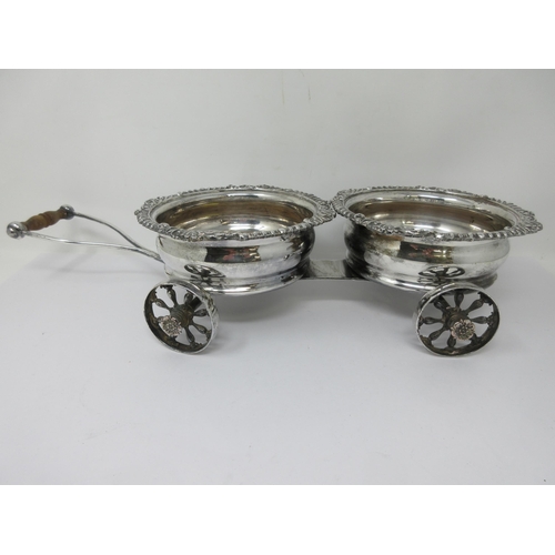 204 - A plated Decanter Wagon with pair of Coasters having gadroon rims and turned wooden bases on four-wh... 