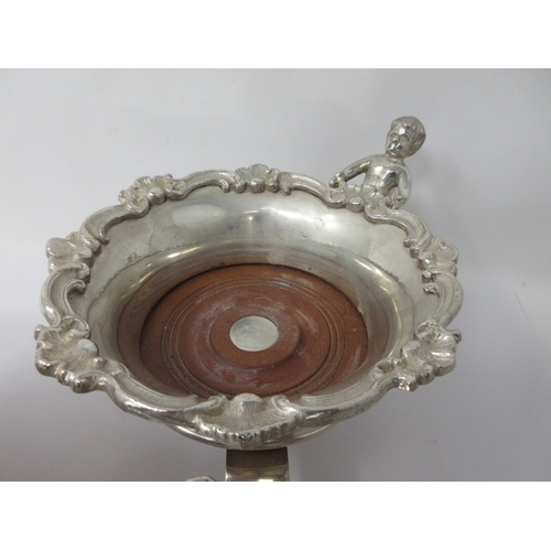 209 - A plated Decanter Wagon with three circular Coasters, having scroll borders, cherub supports, turned... 