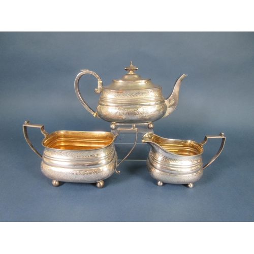 244 - A George III silver three-piece Tea Service of boat shape, engraved leafage friezes, London 1814, ma... 