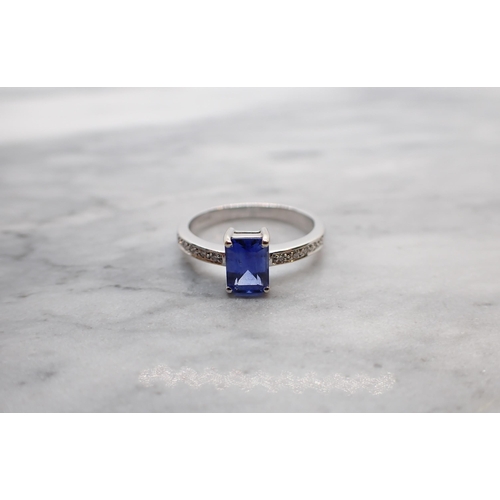 32 - A Sapphire and Diamond Ring corner claw-set step-cut sapphire, 1.53cts, with brilliant-cut diamonds ... 