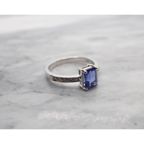 32 - A Sapphire and Diamond Ring corner claw-set step-cut sapphire, 1.53cts, with brilliant-cut diamonds ... 