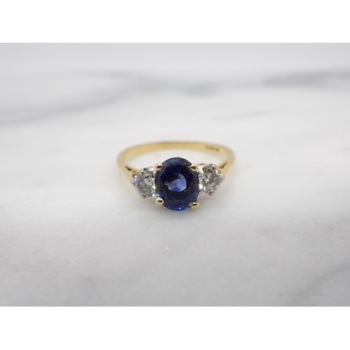 45 - A Sapphire and Diamond three stone Ring claw-set oval-cut sapphire between two brilliant-cut diamond... 