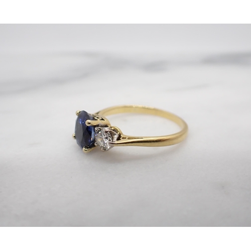 45 - A Sapphire and Diamond three stone Ring claw-set oval-cut sapphire between two brilliant-cut diamond... 