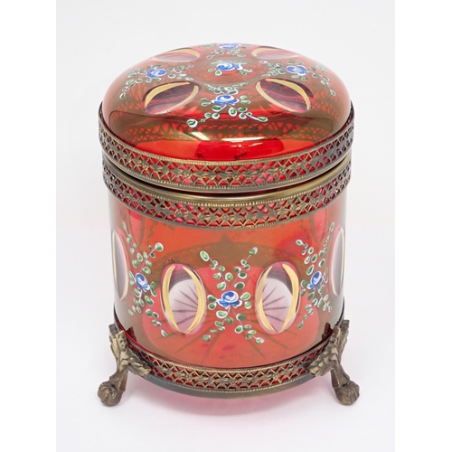 464 - A red glass Box and Cover with gilt metal mounts and cylindrical form having hinged cover and painte... 