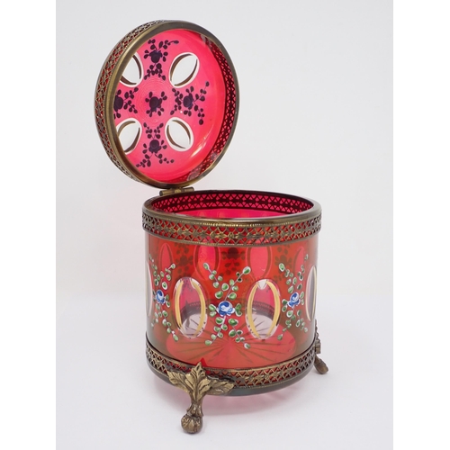 464 - A red glass Box and Cover with gilt metal mounts and cylindrical form having hinged cover and painte... 