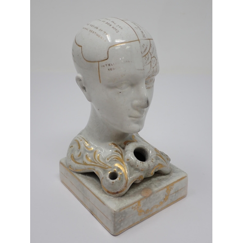 469 - A Phrenology head Inkstand with ink and pen apertures on oblong base, the whole decorated gilt and d... 