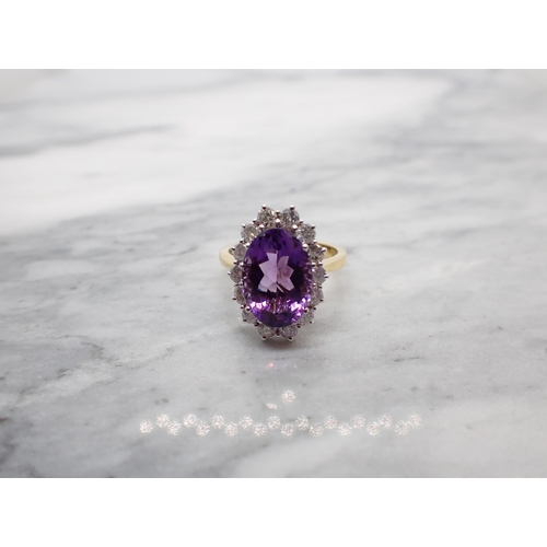 47 - An Amethyst and Diamond Cluster Ring claw-set oval-cut amethyst, 3cts, within a frame of brilliant-c... 