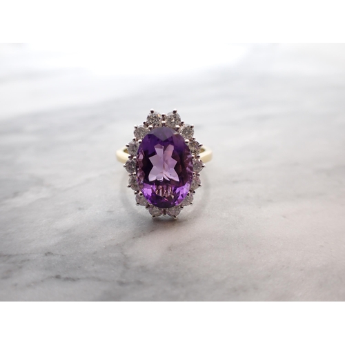 47 - An Amethyst and Diamond Cluster Ring claw-set oval-cut amethyst, 3cts, within a frame of brilliant-c... 