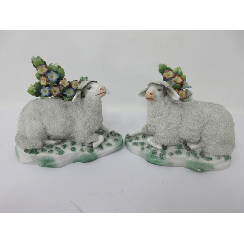 476 - A pair of porcelain gravelware reclining Sheep with painted bocage background, 4in, has a few chips