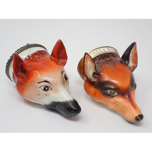 484 - Two fox mask Stirrup Cups, one titled 'Tally Ho' and another with white metal lid having embossed fl... 