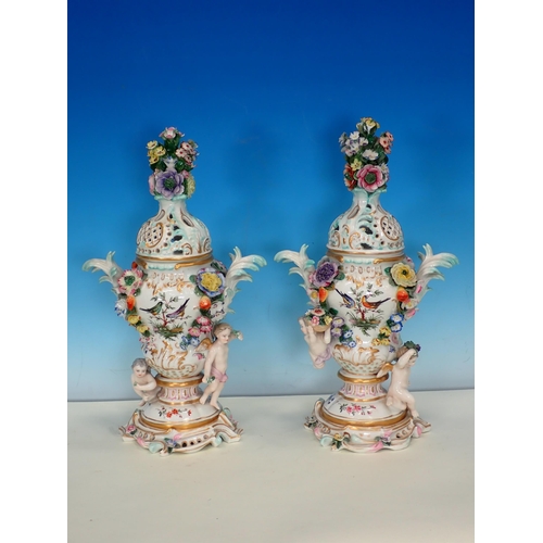 488 - A pair of Continental floral encrusted Vases and Covers, decorated birds on branches and with cherub... 