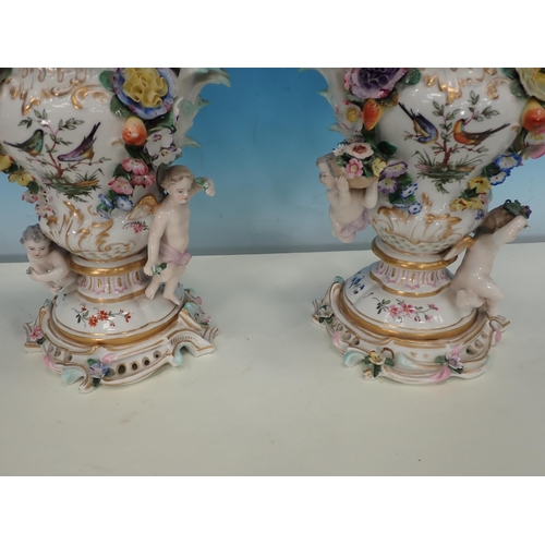 488 - A pair of Continental floral encrusted Vases and Covers, decorated birds on branches and with cherub... 