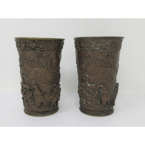 509 - A pair of bronzed Beakers of tapering form relief decorated merrymaking figures in village scene, 5¼... 