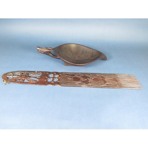 510 - A hardwood Tribal Feeding Bowl with carved mask handle, 16in, and a large Comb with incised and pier... 