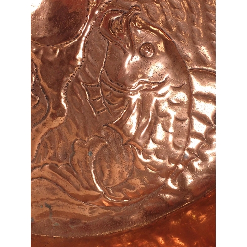 513 - An Arts and Crafts copper Tray in the manner of Newlyn, with embossed fish design and shaped rim, 16... 