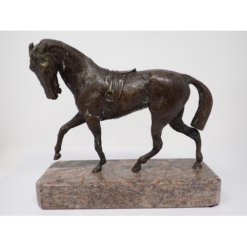 517 - A bronze figure of a Horse with saddle on marble base, 9in L