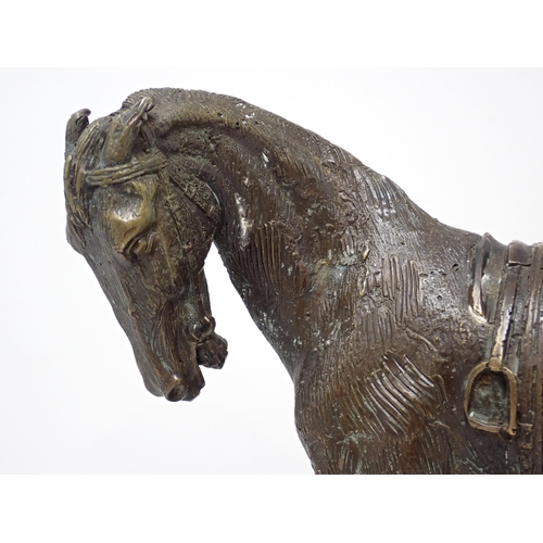 517 - A bronze figure of a Horse with saddle on marble base, 9in L