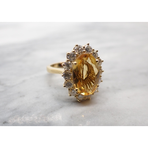 56 - A Citrine and Diamond Cluster Ring claw-set oval-cut citrine, 3cts, within a frame of fourteen brill... 