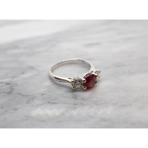 57 - A Ruby and Diamond three stone Ring claw-set round ruby, 1ct, between two brilliant-cut diamonds in ... 