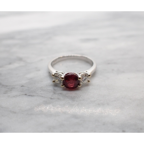 57 - A Ruby and Diamond three stone Ring claw-set round ruby, 1ct, between two brilliant-cut diamonds in ... 