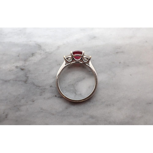 57 - A Ruby and Diamond three stone Ring claw-set round ruby, 1ct, between two brilliant-cut diamonds in ... 