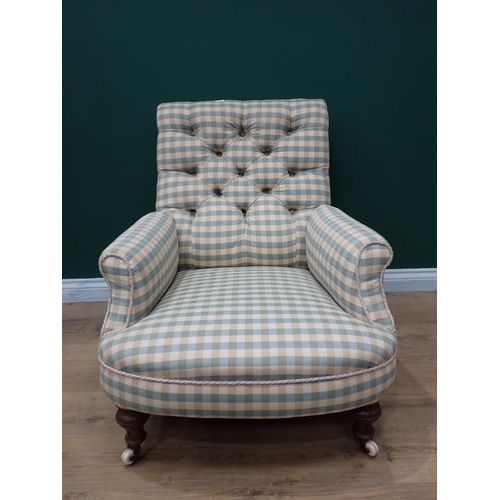 597 - A 19th Century Armchair with chequered button upholstery on turned front supports and casters (two c... 