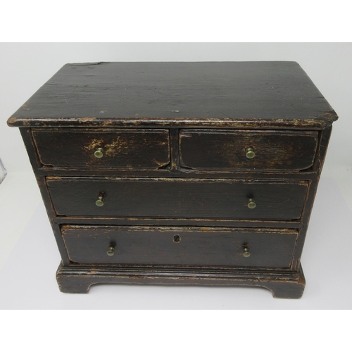 600 - A 19th Century Apprentice Piece stained pine Chest of two short and two long drawers on bracket feet... 