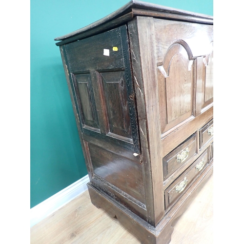 487 - An 18th Century oak Mule Chest with hinged cover above arched panelled front above an arrangement of... 