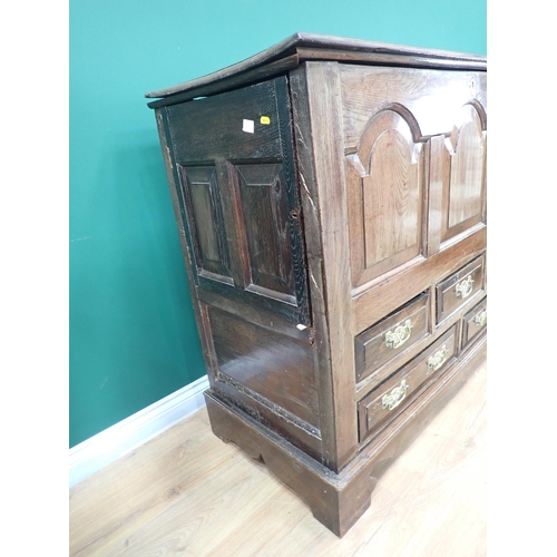 487 - An 18th Century oak Mule Chest with hinged cover above arched panelled front above an arrangement of... 