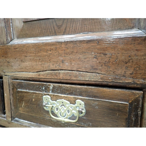 487 - An 18th Century oak Mule Chest with hinged cover above arched panelled front above an arrangement of... 