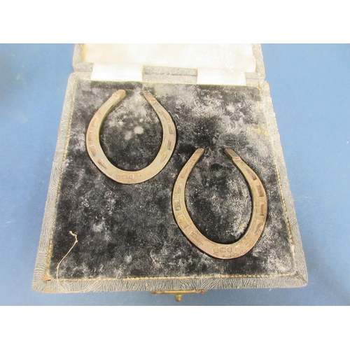 113 - A pair of Elizabeth II silver Napkin Rings in the form of horseshoes, Sheffield 1959, and an Edward ... 