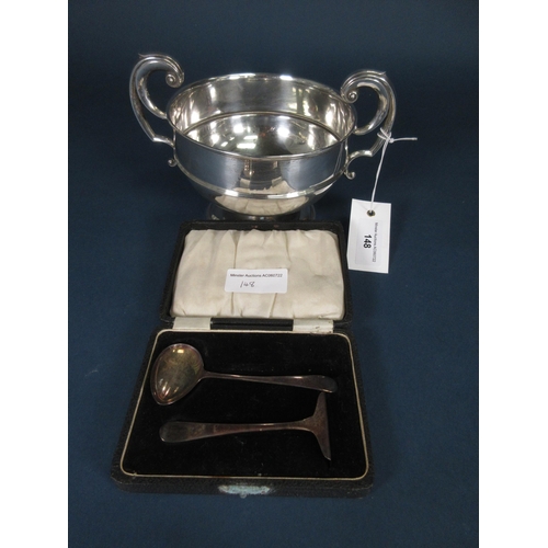 148 - A George V silver two handled Trophy, Birmingham 1911, 330gms and a silver Pusher and Spoon, Sheffie... 