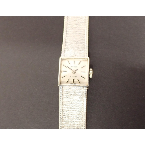 153 - A lady's 1970's Tissot 'Stylist' Wristwatch the square silvered dial with hourly baton markers on in... 