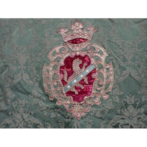 201 - A 19th Century green damask Wall Hanging with appliquéd heraldic crest within borders of scrolls, co... 